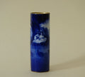 Two girls cross-legged under trees Blue children vase